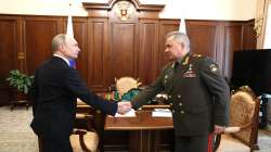 Russian President Vladimir Putin, left, and Russian Defence Minister Sergey Shoigu shake hands during their meeting at the Kremlin in Moscow