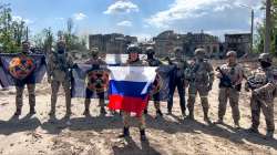 The head of the Wagner Group military company speaks holding a Russian national flag in front of his soldiers in Bakhmut,