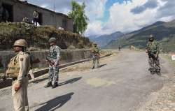 Security personnel near the site of an encounter with terrorists in Kandi area of Rajouri district