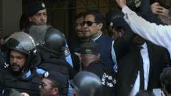 Pakistans former Prime Minister Imran Khan, center, is escorted by police officers as he arrives to appear in a court, in Islamabad, Pakistan.