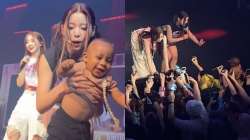 Baby crawls on stage from crowd at K-pop concert