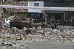 A burnt car is seen in front of the damaged fast food restaurant after a nightly Russian rocket attack in Odesa, Ukraine