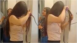 Girl using hair straightener inside Delhi Metro