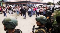 Family members wait outside the entrance of the women's prison in Tamara