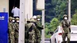 Japanese Self Defense Force members gather near a facility in a base firing range