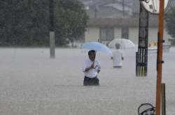 Two people died as heavy rains lash Japan.