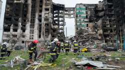 Emergency workers carry debris from building destroyed in Russian air raid in Borodyanka