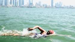 Woman swimming toward Gateway of India, Mumbai.