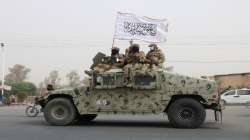 Taliban patrol on road during celebration marking second anniversary of withdrawal of US troops from Afghanistan