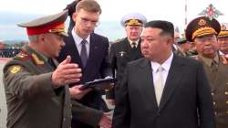 Kim Jong Un, right, listens to Russian Defense Minister Sergei Shoigu, left, as he inspects Russian warplanes at Vladivostok