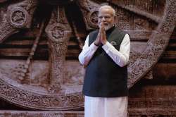 Prime Minister Narendra Modi greets as waits to welcome leaders of the G20 countries, in New Delhi