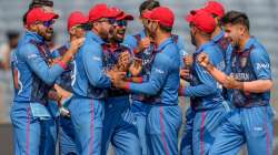 Fazalhaq Farooqi celebrates with fellow teammates at MCA Stadium in Pune.