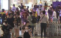 Tourists evacuating from Bangkok’s Siam Paragon Mall after gunfire was heard.