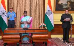 President Droupadi Murmu administering the oath to Heeralal Samariya as Chief Information Commissioner 