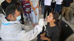 A healthcare worker collects sample of an NCC cadet for Covid-19 test.