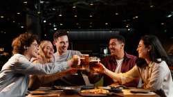 Friends enjoying with beer mugs in their hands