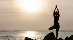 woman doing yoga at sunset