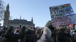 Pro-Palestinian activists gather near the International Court of Justice.