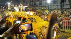 Prime Minister Narendra Modi waves to supporters during a roadshow, in Kerala's Ernakulam district.