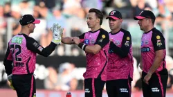 Tom Curran celebrates with his Sydney Sixers teammates.