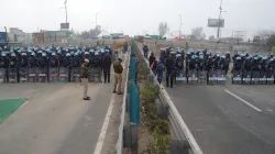 Police and security personnel stand guard near multi-layered barricading ahead of the protesting farmers’ ‘Delhi Chalo’ March, at the Singhu Border, in New Delhi.