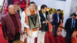 Uttarakhand Chief Minister Pushkar Singh Dhami with others holds a copy of the Constitution of India, at Vidhan Sabha Bhawan, in Dehradun as the Uniform Civil Code bill was tabled in the State Assembly.