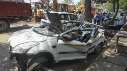 Wreckage of a vehicle that was damaged after a 100-foot tall illegal billboard fell on a petrol pump on Monday due to rains and dust storm