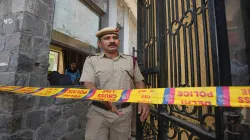 A police personnel exits the Mother Mary’s School, Mayur Vihar after multiple schools received bomb threats via e-mail, in New Delhi.