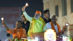 Prime Minister Narendra Modi with Uttar Pradesh Chief Minister Yogi Adityanath during a roadshow for Lok Sabha elections in Ayodhya.