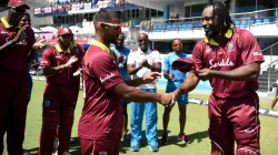 Chris Gayle presents debut cap to Nicholas Pooran.