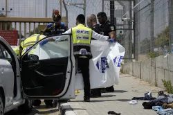 Israeli officials work at the scene of an attempted stabbing attack that Israeli police say was carr