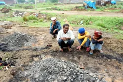 A man named Vinod (in white) with his sons mourns as he performs last rites of his family members who were killed in a stampede during a satsang