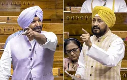 Union Minister of State and BJP MP Ravneet Singh (L) and Congress MP Charanjit Singh Channi speak in the Lok Sabha during the Monsoon session of Parliament