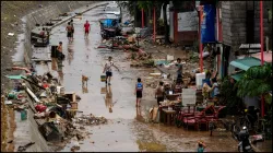 Residents salvage their belongings following the floods brought by Typhoon Gaemi in the Philippines