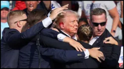 Former US President Donald Trump is assisted by the Secret Service after an assassination attempt.