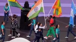 Manu Bhaker and PR Sreejesh with India's flag.