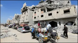 Displaced Palestinians make their way as they flee Hamad City following an Israeli evacuation order.