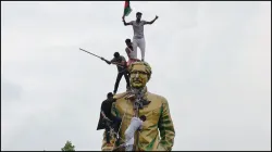 People climb the statue of Sheikh Mujibur Rahman at the Bijoy Sarani area after Sheikh Hasina's ouster.