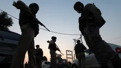 Jammu & Kashmir Police officers are positioned near the site of the ongoing encounter between security forces and terrorists.