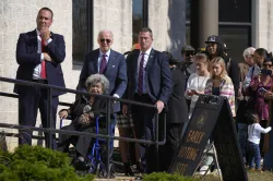 US President Joe Biden, standing in a queue at a polling station alongside first-time voters after casting his early-voting ballot for the 2024 general elections