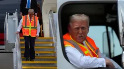 Republican presidential nominee former President Donald Trump talks to reporters as he sits in a garbage truck Wednesday