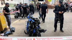 Israeli police stand around the motorbike of the attacker following a stabbing attack in Hadera.