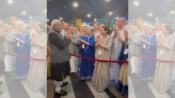 Russian nationals sing Krishna Bhajan before Prime Minister Narendra Modi, as they welcome him to Ka