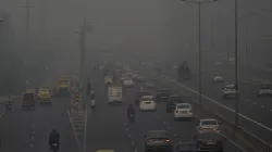 Vehicles ply on a road amid low visibility due to smog in Delhi