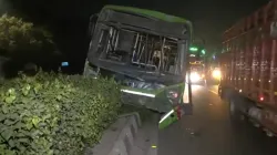 The bus is damaged after hitting a divider