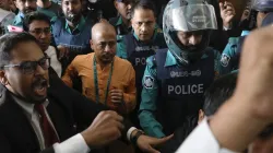 Chinmoy Krishna Das being escorted by the police at the Chattogram Metropolitan Magistrate Court in Chattogram
