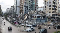 Vehicles drive past damaged buildings in Beirut's southern suburbs, after a ceasefire between Israel and Hezbollah took effect, Lebanon November 27