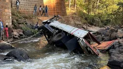 People view a truck that fell off the Gelan Bridge as it was returning from a wedding ceremony in the southern Sidama region of Ethiopia