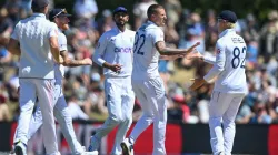 Brydon Carse celebrates a wicket with his teammates.