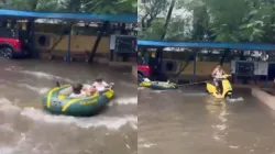 Screen grab of video showing a man and his grandchildren in a waterlogged residential complex